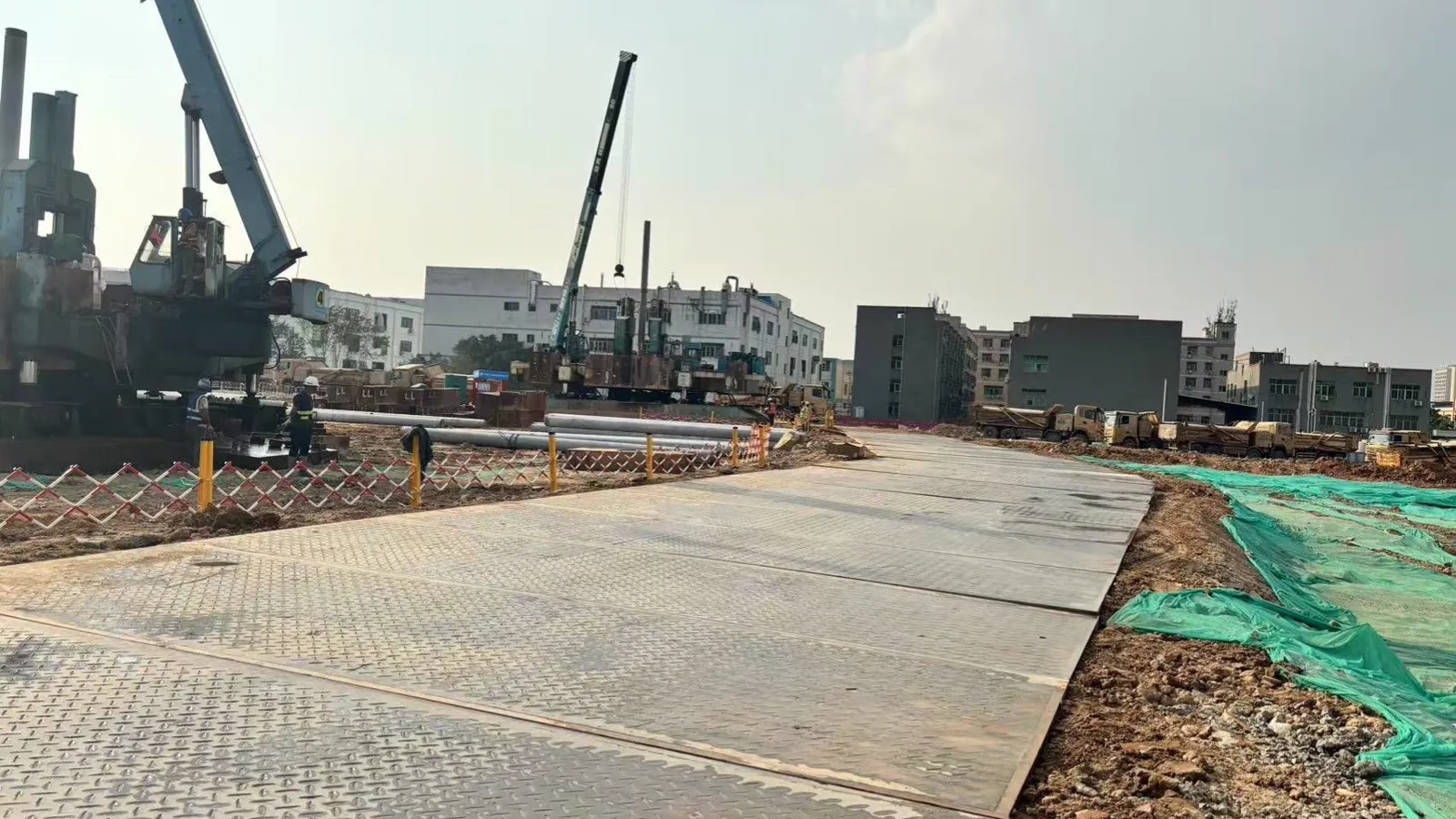 Connected HDPE mats forming a flat working platform under a crane