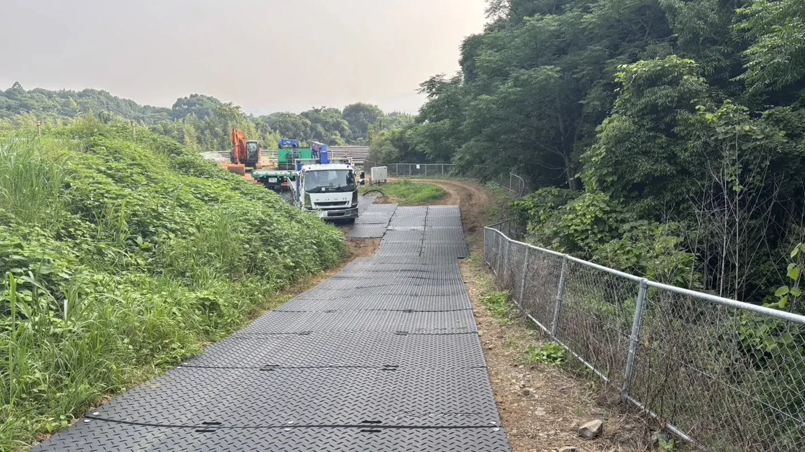 HDPE track mats laid as a temporary access road through dense forest