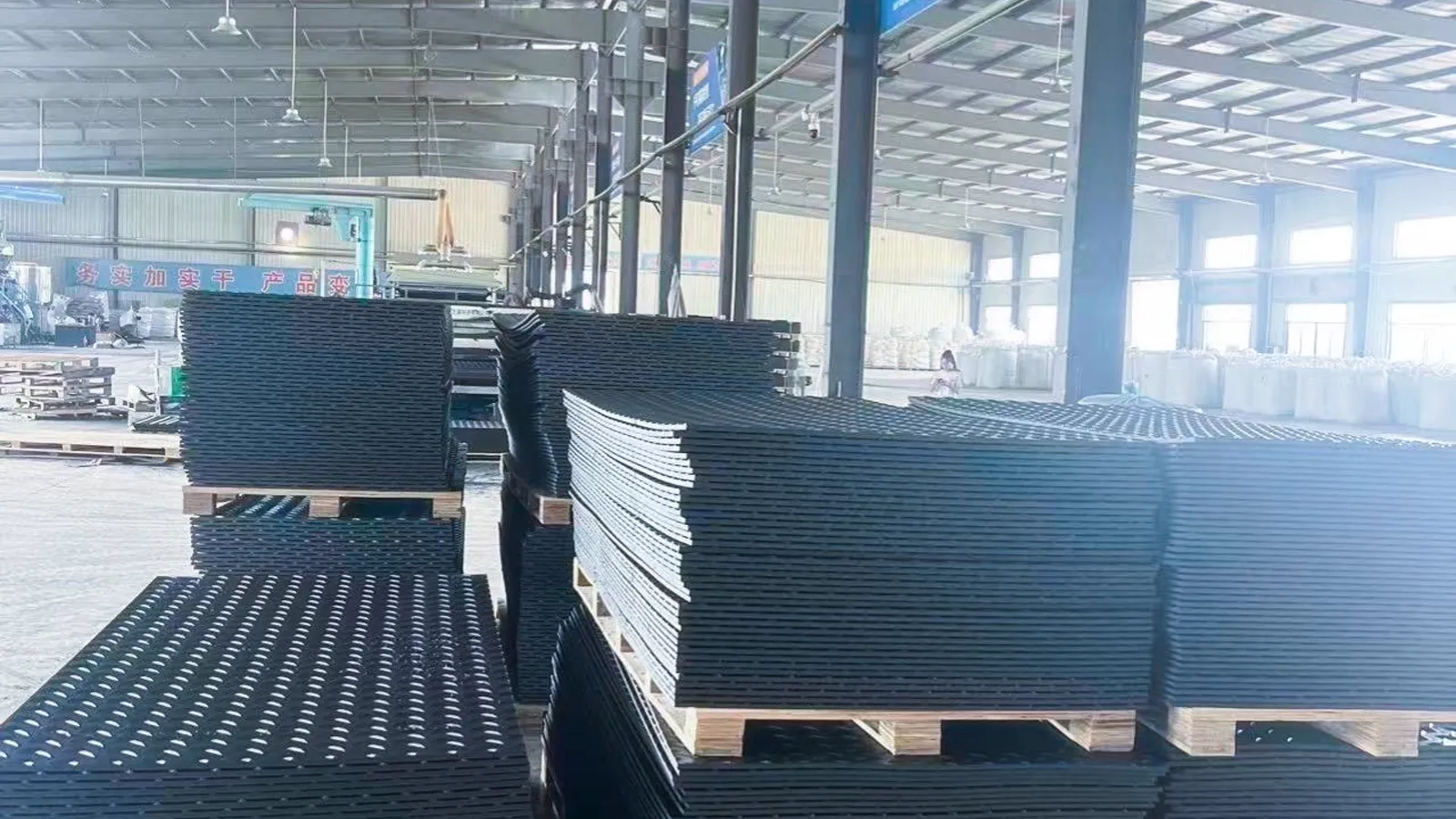 Stacked HDPE track mats on pallets ready for container loading